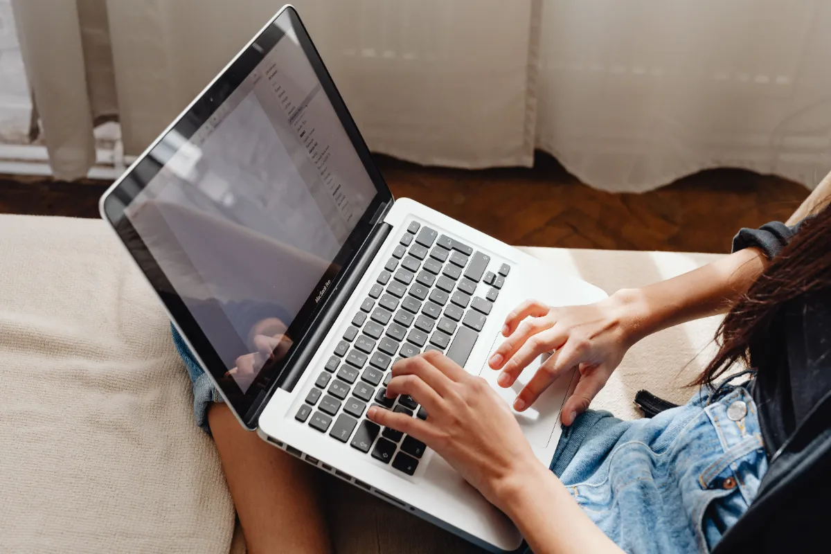 A person signing in to an account from a laptop and phone
